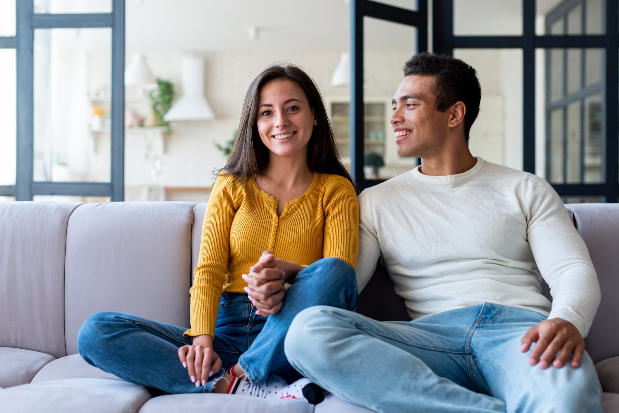 A first-time member smiling with their family at home