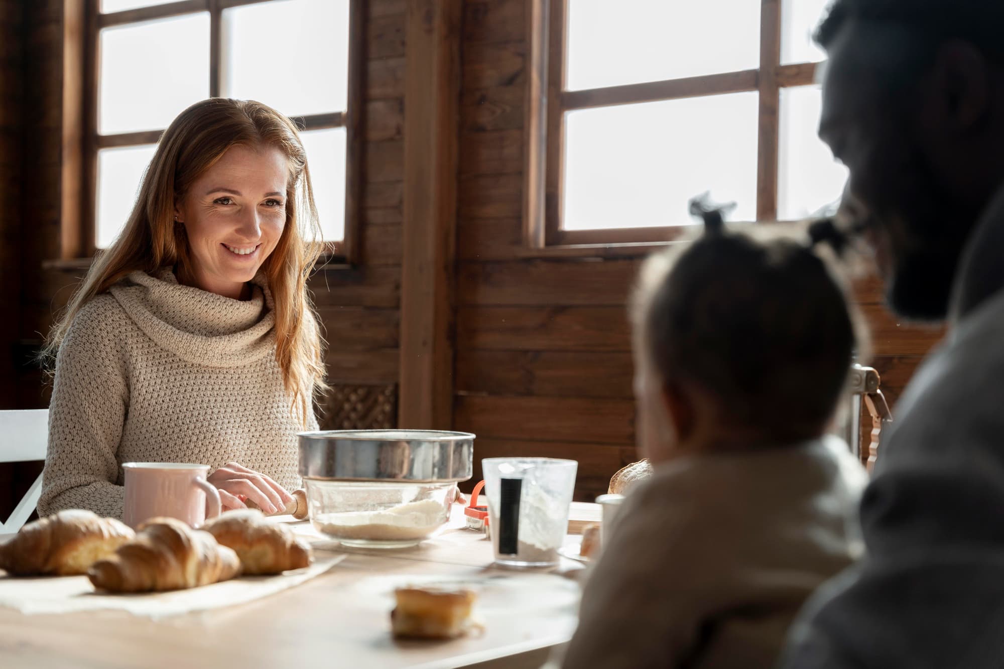 Young adult at home in their first apartment, natural evening light, working from a kitchen island